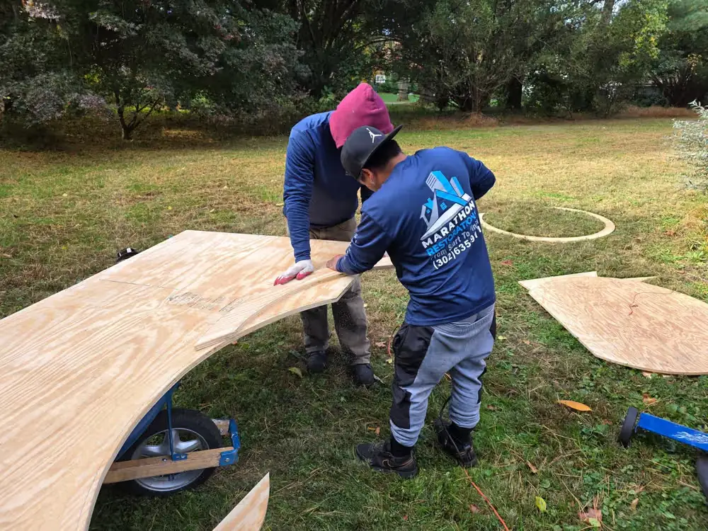Working-Crew-Cutting-Plywood-On-Lawn